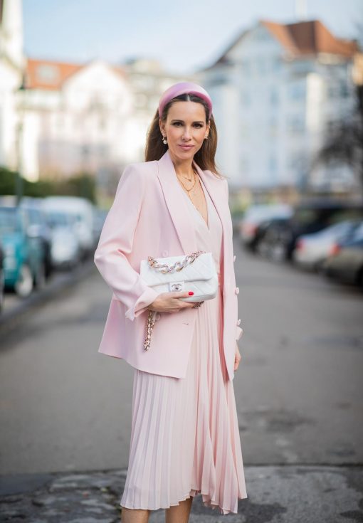 DUESSELDORF, GERMANY : Alexandra Lapp is seen wearing a monochrome look Riani, pink pleated dress, pink oversized blazer, white Chanel bag on December 11, 2019 in Duesseldorf, Germany. (Photo by Christian Vierig/Getty Images)