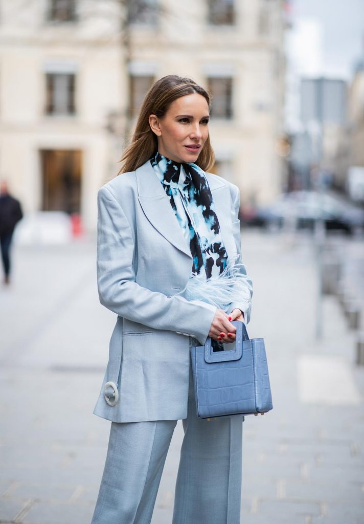 PARIS, FRANCE - FEBRUARY 25: Alexandra Lapp is seen wearing a suit style, light blue De La Vali suit, blue Shirley mini bag from Staud, 16Arlington satin top with feathers, Prada pumps in light blue, square-frame black Bottega Veneta sunglasses all from Net-A-Porter during Paris Fashion Week - Womenswear Fall/Winter 2020/2021 : Day Two on February 25, 2020 in Paris, France.