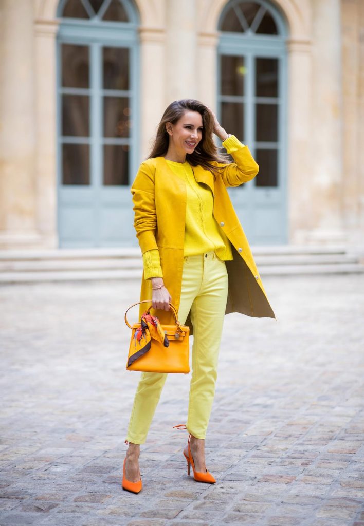 PARIS, FRANCE - FEBRUARY 26: Alexandra Lapp is seen wearing a yellow trend, leather coat in yellow from Milestone by Peter Hahn, yellow Looxent pullover from Peter Hahn, MYBC Jeans from Peter Hahn, slingback-pumps in orange from The Attico, 28 Hermes Kelly bag in orange, silk scarf from Hermes during Paris Fashion Week - Womenswear Fall/Winter 2020/2021 : Day Three on February 26, 2020 in Paris, France.