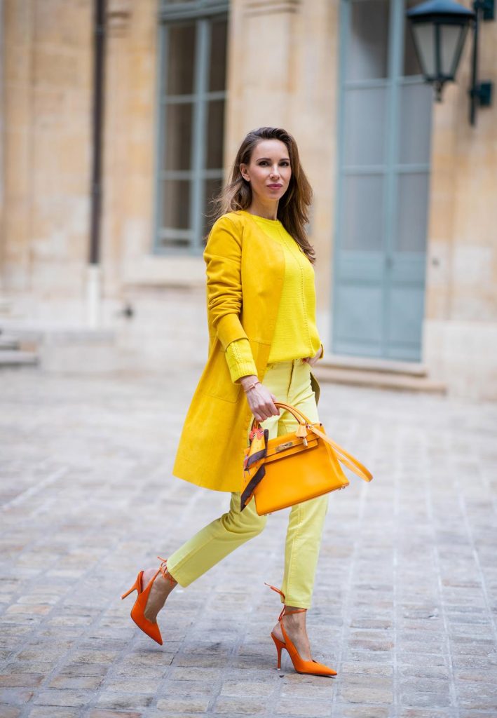 PARIS, FRANCE - FEBRUARY 26: Alexandra Lapp is seen wearing a yellow trend, leather coat in yellow from Milestone by Peter Hahn, yellow Looxent pullover from Peter Hahn, MYBC Jeans from Peter Hahn, slingback-pumps in orange from The Attico, 28 Hermes Kelly bag in orange, silk scarf from Hermes during Paris Fashion Week - Womenswear Fall/Winter 2020/2021 : Day Three on February 26, 2020 in Paris, France.