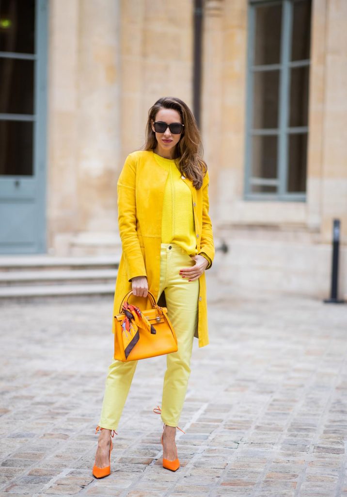PARIS, FRANCE - FEBRUARY 26: Alexandra Lapp is seen wearing a yellow trend, leather coat in yellow from Milestone by Peter Hahn, yellow Looxent pullover from Peter Hahn, MYBC Jeans from Peter Hahn, slingback-pumps in orange from The Attico, 28 Hermes Kelly bag in orange, silk scarf from Hermes during Paris Fashion Week - Womenswear Fall/Winter 2020/2021 : Day Three on February 26, 2020 in Paris, France.