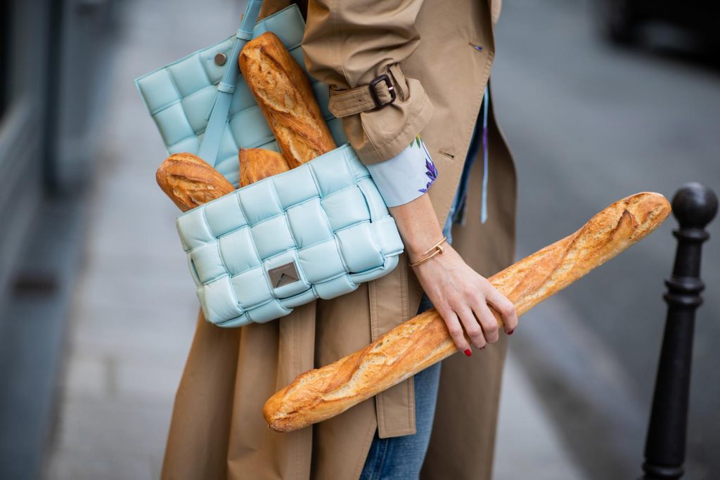 PARIS, FRANCE - FEBRUARY 25: Alexandra Lapp is seen wearing Jeans Jane Flare from Celine, double breasted trench coat from Valentino, Stella McCartney blouse, Bottega Veneta Padded Cassette bag in leather in light blue, Bottega Veneta sunglasses - all from Breuninger during Paris Fashion Week - Womenswear Fall/Winter 2020/2021