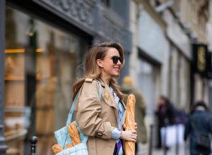 PARIS, FRANCE - FEBRUARY 25: Alexandra Lapp is seen wearing Jeans Jane Flare from Celine, double breasted trench coat from Valentino, Stella McCartney blouse, Bottega Veneta Padded Cassette leather bag in light blue, Bottega Veneta sunglasses - all from Breuninger during Paris Fashion Week - Womenswear Fall/Winter 2020/2021