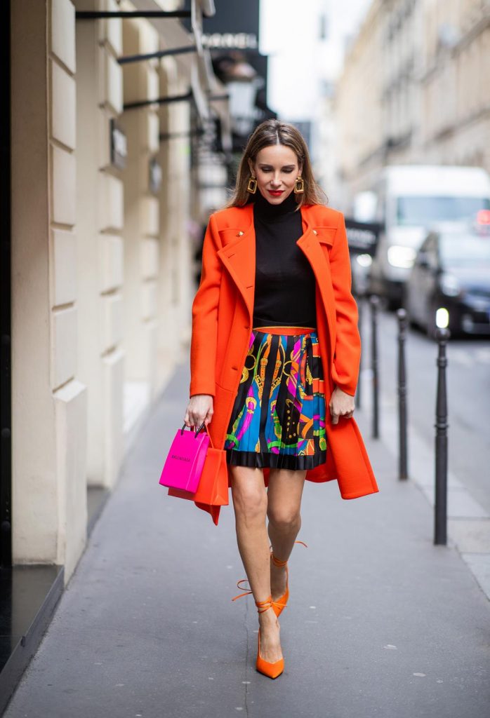 Alexandra Lapp, Givenchy, Versace, Dorothee Schumacher, slingback pumps, The Attico, Balenciaga, Medea, Paris Fashion Week, Womenswear Fall/Winter 2020/2021 PARIS, FRANCE - FEBRUARY 26: Alexandra Lapp is seen wearing a Givenchy coat in orange, pleated silk skirt from Versace, turtleneck pullover in black from Dorothee Schumacher, slingback pumps in orange from The Attico, Balenciaga Tote Shopping Phone bag, Medea Vinile Short bag during Paris Fashion Week - Womenswear Fall/Winter 2020/2021 : Day Three on February 26, 2020 in Paris, France.