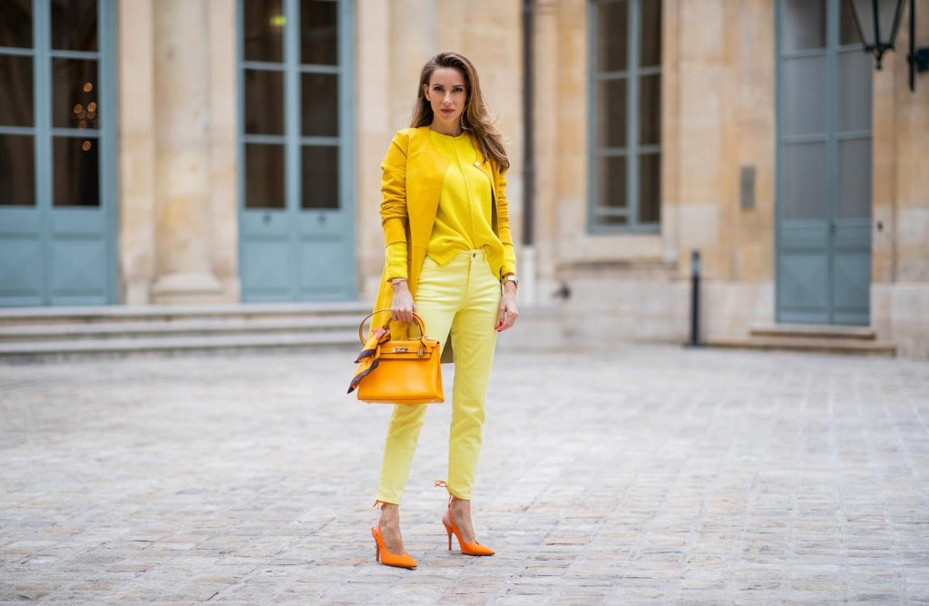 PARIS, FRANCE - FEBRUARY 26: Alexandra Lapp is seen wearing a yellow trend, leather coat in yellow from Milestone by Peter Hahn, yellow Looxent pullover from Peter Hahn, MYBC Jeans from Peter Hahn, slingback-pumps in orange from The Attico, 28 Hermes Kelly bag in orange, silk scarf from Hermes during Paris Fashion Week - Womenswear Fall/Winter 2020/2021 : Day Three on February 26, 2020 in Paris, France.