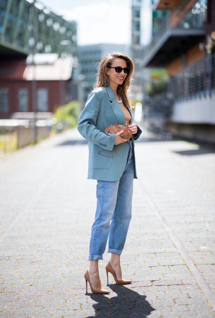 DUSSELDORF, GERMANY - JUNE 09: Alexandra Lapp is seen wearing a casual chic look, Victoria Beckham tanktop in beige, GRLFRND high waist Jeans Devon, double breasted blazer in blue from Low Classic, the Pouch mini clutch from Bottega Veneta and Dylan cat-eye sunglasses in black with silver all from NET-A-PORTER is seen on June 09, 2020 in Dusseldorf, Germany. 