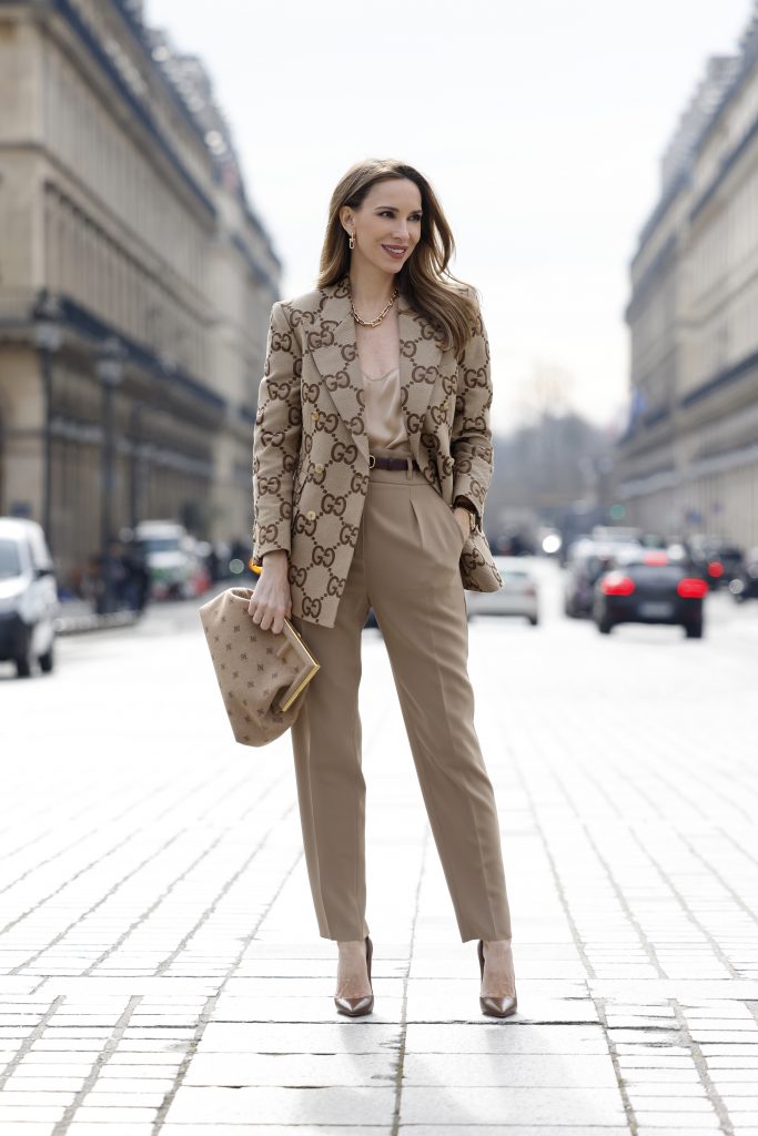 Alexandra Lapp, Gucci logo print, Chanel, Fendi, Celine, Agolde, Blazer, Jacket, Chanel, Saint Laurent, Streetstyle Shooters, Max Mara, Tiffany & Co., Saint Laurent, Gianvito Rossi, Aquazzura Alexandra Lapp is seen wearing Gucci logo print blazer in beige, Jadicted silk top in beige, Gucci leather belt in brown, Fendi clutch in beige, Max Mara pants in beige, Christian Louboutin So Kate pumps in dark brown, and Bottega Veneta. Complete look by Breuninger.