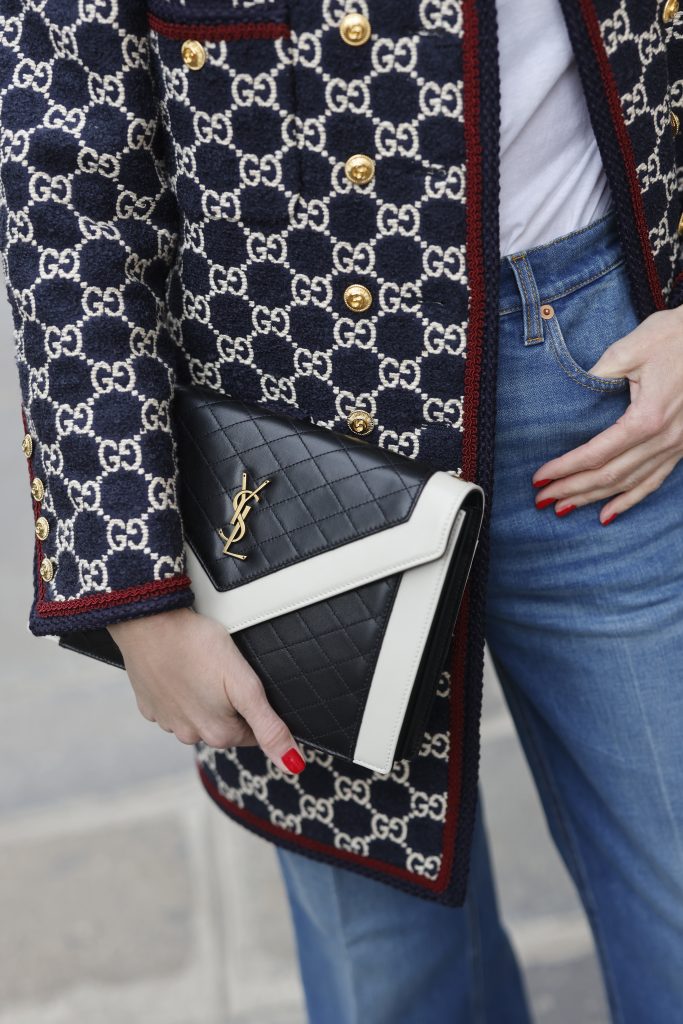 Alexandra Lapp, Gucci logo print, Chanel, Fendi, Celine, Agolde, Blazer, Jacket, Chanel, Saint Laurent, Streetstyle Shooters, Max Mara, Tiffany & Co., Saint Laurent, Gianvito Rossi, Aquazzura Alexandra Lapp is seen wearing the GUCCI logo print Caban Jacket in the Gucci pattern, JAMES PEARSE t-shirt in white, GUCCI washed denim flair trousers with Gucci label, GIANVITO ROSSI ribbon point flats in vitello white, SAINT LAURENT handbag in black and white, and BOTTEGA VENETA square acetate sunglasses in black. Complete look by Breuninger.