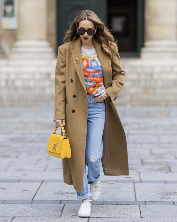 Alexandra Lapp is seen wearing her Winter highlights during Paris Fashion Week, such as coats, chunky knits, statement ear rings and accessories, as well as her signature make-up.
