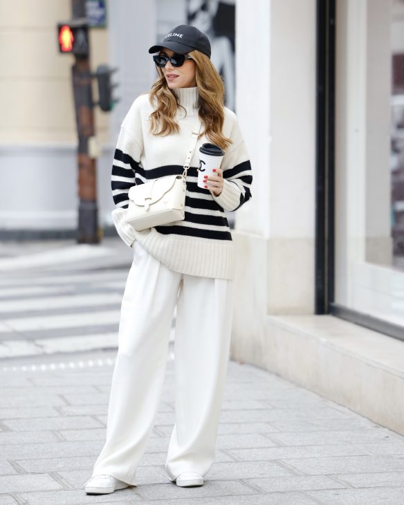 Alexandra Lapp is seen wearing her Winter highlights during Paris Fashion Week, such as coats, chunky knits, statement ear rings and accessories, as well as her signature make-up.