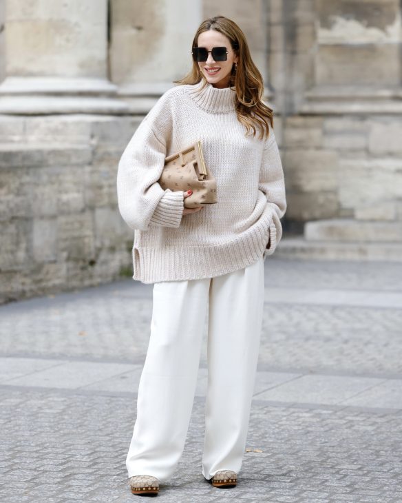 Alexandra Lapp is seen wearing her Winter highlights during Paris Fashion Week, such as coats, chunky knits, statement ear rings and accessories, as well as her signature make-up.