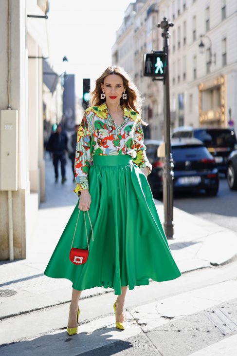 Alexandra Lapp is seen wearing colorful looks during Fashion Week in Paris. ODEEH blouse, C.WIRSCHKE green satin skirt, CHRISTIAN LOUBOUTIN Hot Chick pumps in yellow, FOR ART’S SAKE sunglasses, HERMES Kelly bag.