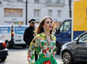 Alexandra Lapp is seen wearing colorful looks during Fashion Week in Paris. ODEEH blouse, C.WIRSCHKE green satin skirt, CHRISTIAN LOUBOUTIN Hot Chick pumps in yellow, FOR ART’S SAKE sunglasses, HERMES Kelly bag.
